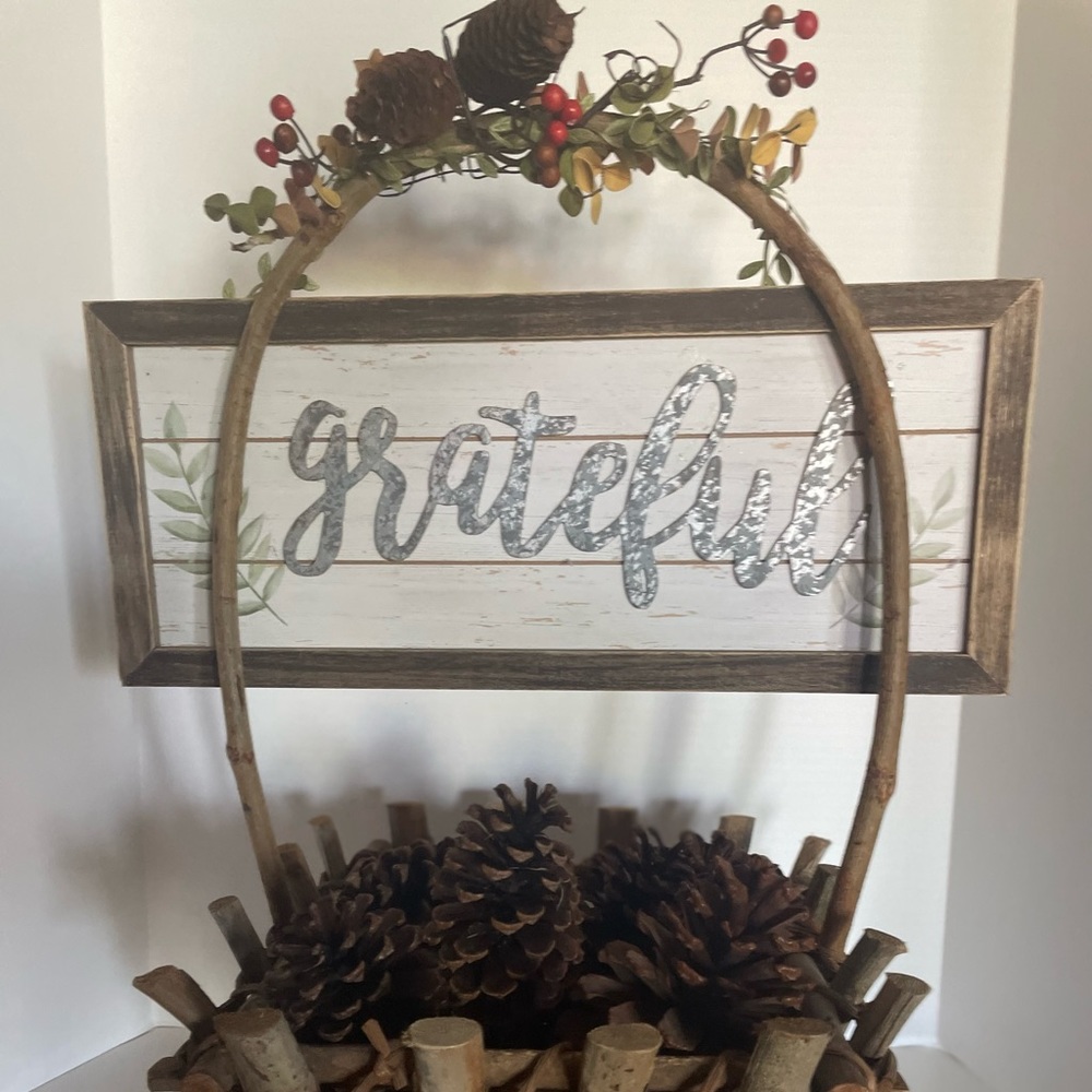 Vintage basket- filled with pine comes and a “Thankful” plaque